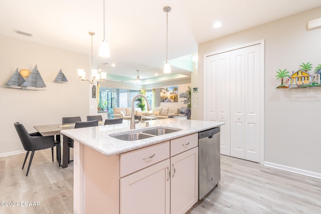 kitchen with light hardwood / wood-style floors, sink, stainless steel dishwasher, an island with sink, and pendant lighting