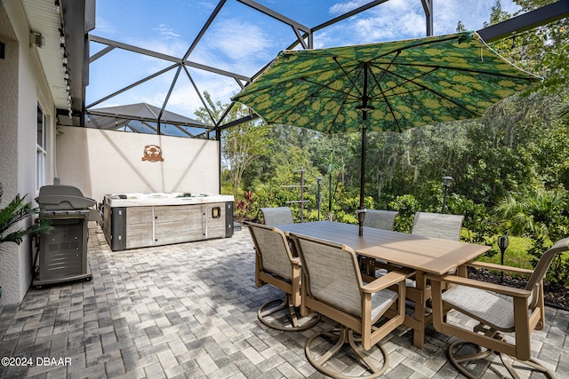 view of patio featuring glass enclosure and area for grilling