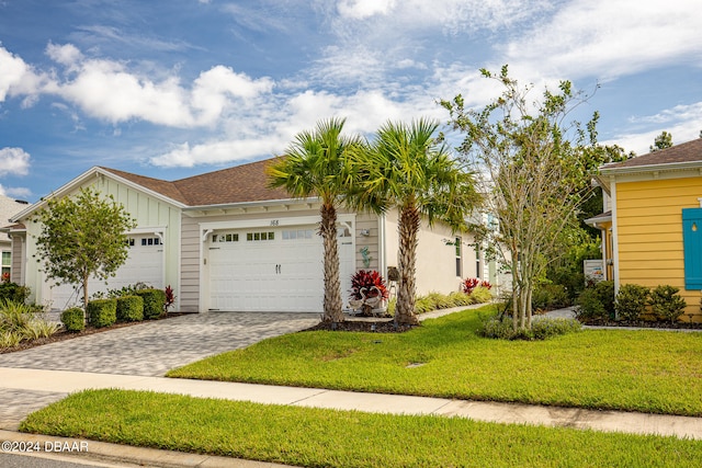 view of front of home featuring a front lawn and a garage