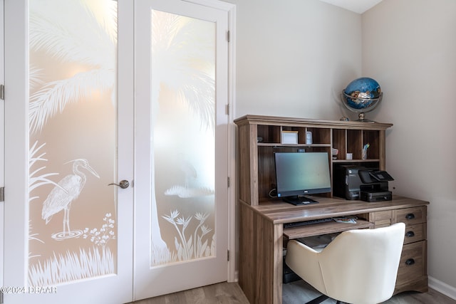 office space featuring light hardwood / wood-style floors and french doors