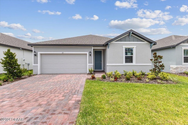 ranch-style home with a garage and a front lawn