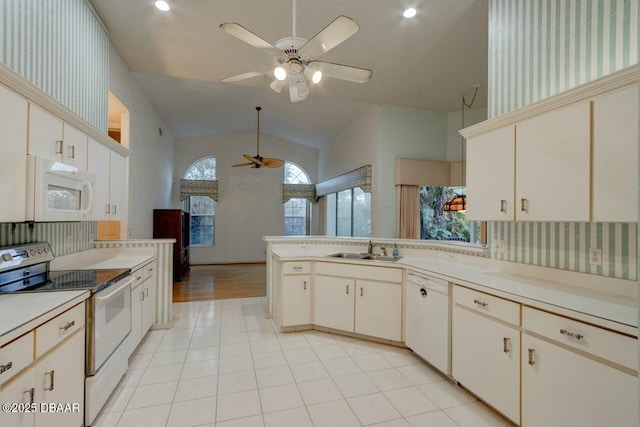 kitchen with lofted ceiling, sink, light tile patterned floors, ceiling fan, and white appliances