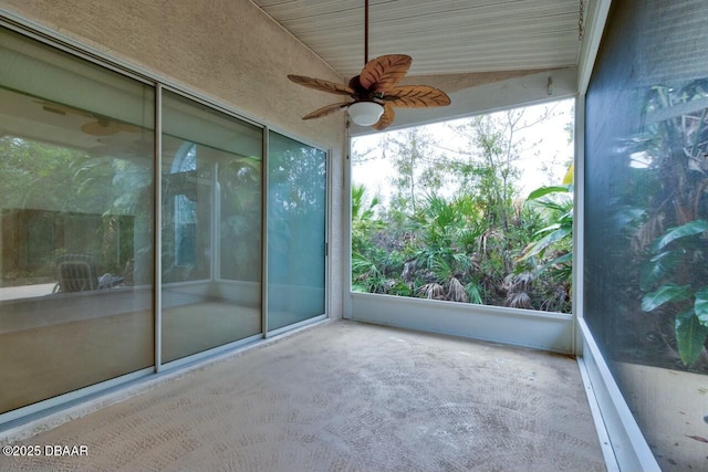 unfurnished sunroom with ceiling fan