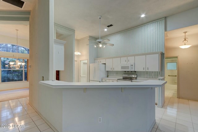 kitchen featuring light tile patterned floors, white appliances, ceiling fan with notable chandelier, and white cabinets