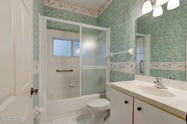 full bathroom featuring tile patterned flooring, vanity, shower / bath combination with glass door, and toilet