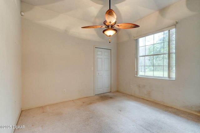 empty room featuring light carpet and ceiling fan