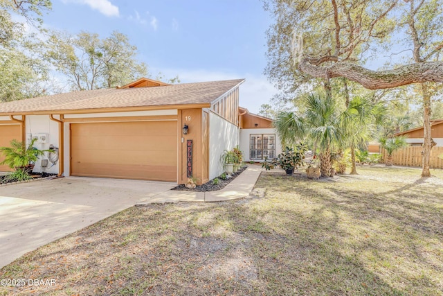 view of front of home featuring a garage and a front yard