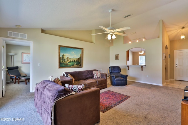 living room featuring ceiling fan, light colored carpet, and vaulted ceiling