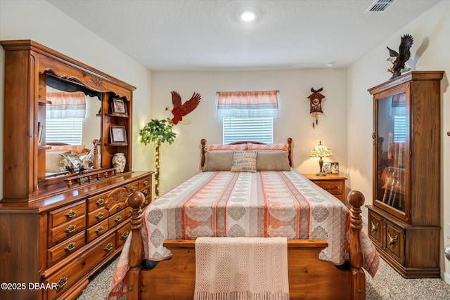 bedroom with multiple windows and carpet