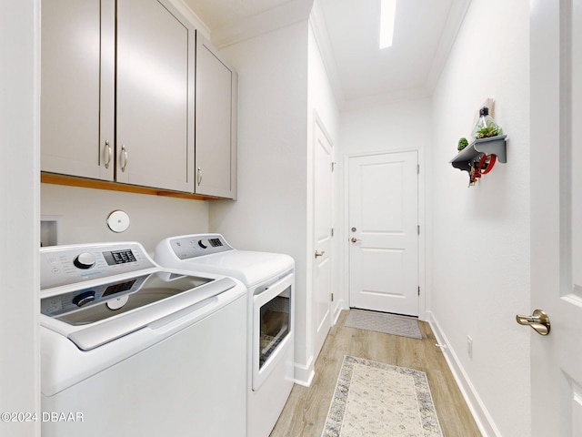 laundry area with separate washer and dryer, light wood-style flooring, cabinet space, and ornamental molding