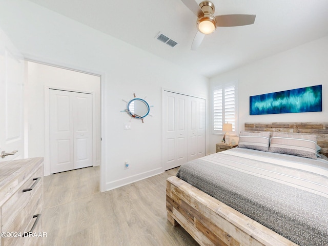 bedroom with light wood finished floors, a ceiling fan, baseboards, visible vents, and a closet