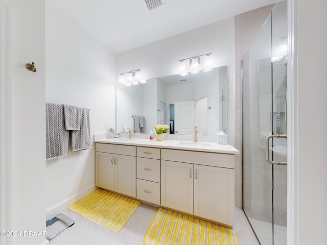 bathroom featuring a sink, double vanity, baseboards, visible vents, and a stall shower