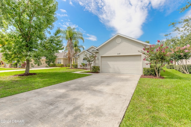 view of front of house with a front lawn and a garage