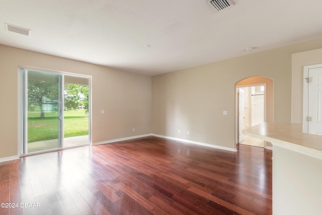 empty room with dark wood-type flooring