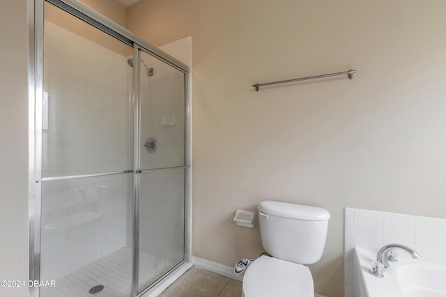 bathroom featuring tile patterned flooring, shower with separate bathtub, and toilet