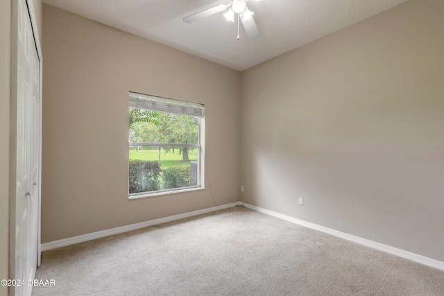 carpeted empty room with ceiling fan