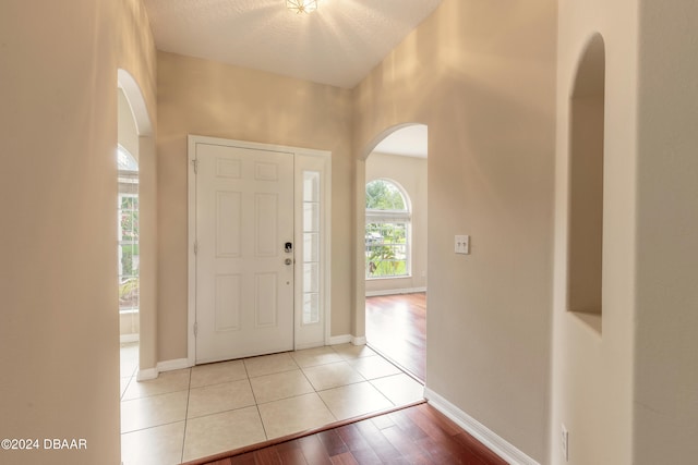 foyer featuring light hardwood / wood-style floors and a textured ceiling