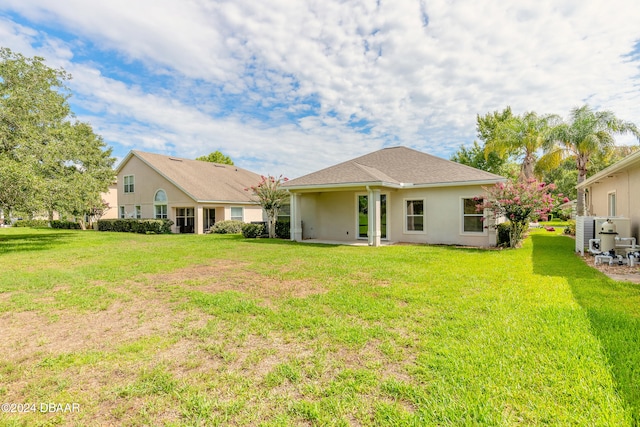 back of house with a yard