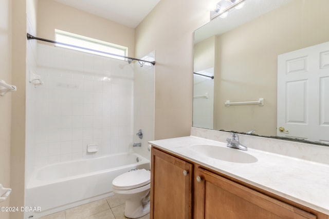 full bathroom featuring tile patterned flooring, tiled shower / bath, toilet, and vanity