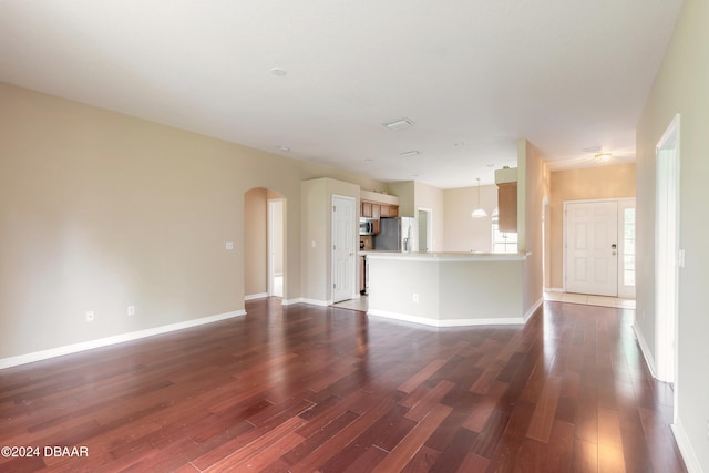 unfurnished living room featuring dark hardwood / wood-style flooring