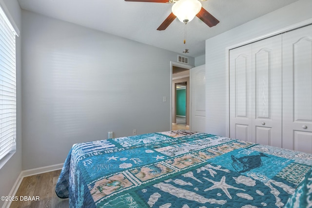 3328 Marsili Ave, New Smyrna Beach, FL 32168 - bedroom with baseboards, visible vents, a ceiling fan, wood finished floors, and a closet