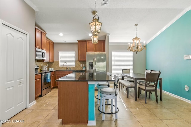 3328 Marsili Ave, New Smyrna Beach, FL 32168 - kitchen featuring tasteful backsplash, light tile patterned flooring, appliances with stainless steel finishes, a kitchen bar, and ornamental molding