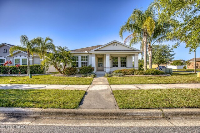 3328 Marsili Ave, New Smyrna Beach, FL 32168 - bungalow featuring a porch, a front lawn, and stucco siding