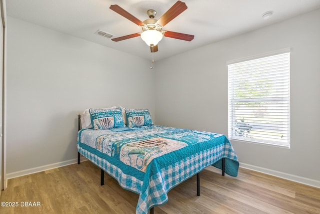 3328 Marsili Ave, New Smyrna Beach, FL 32168 - bedroom featuring wood finished floors, visible vents, a ceiling fan, and baseboards
