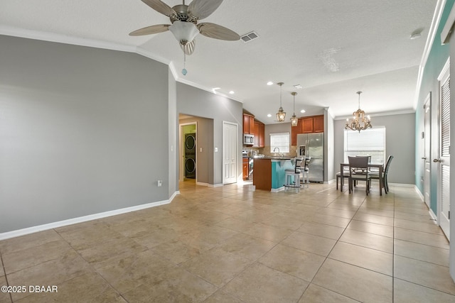 3328 Marsili Ave, New Smyrna Beach, FL 32168 - living room with light tile patterned flooring, baseboards, visible vents, ceiling fan with notable chandelier, and ornamental molding