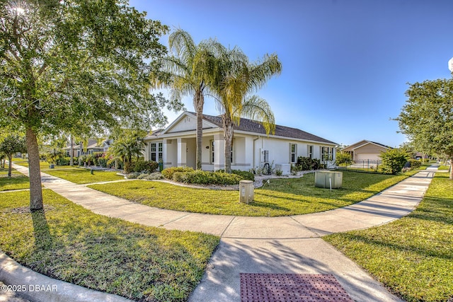 3328 Marsili Ave, New Smyrna Beach, FL 32168 - view of front of home featuring stucco siding, fence, and a front yard