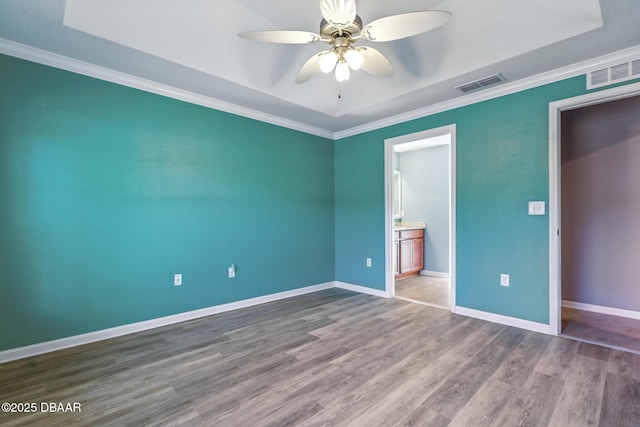 3328 Marsili Ave, New Smyrna Beach, FL 32168 - unfurnished bedroom with wood finished floors, visible vents, crown molding, and baseboards