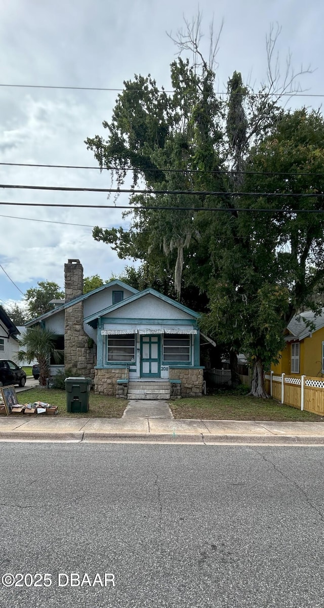 208 Bellevue Ave, Daytona Beach, FL 32114 - bungalow-style home with a chimney and stone siding