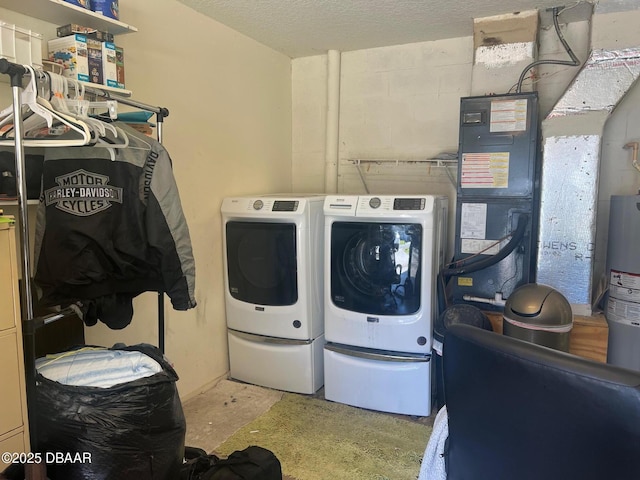 laundry room featuring washer and clothes dryer and a textured ceiling