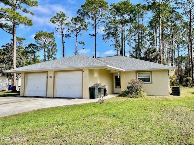 ranch-style home with cooling unit, a garage, and a front yard