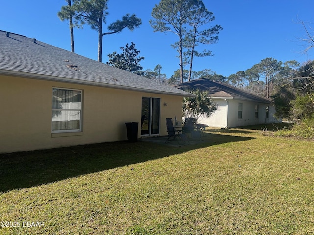 rear view of house with a yard