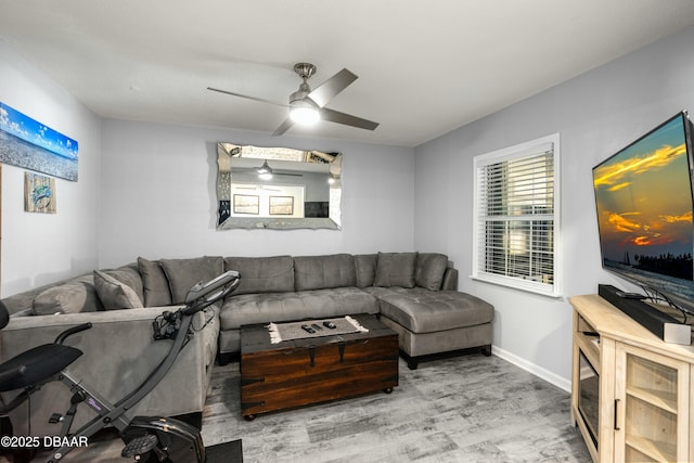 living room featuring hardwood / wood-style floors and ceiling fan