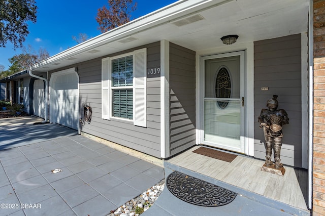 view of exterior entry with a garage