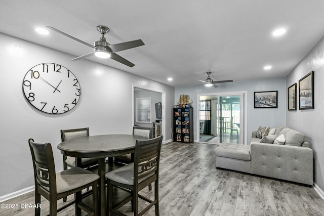 dining area with ceiling fan and light wood-type flooring