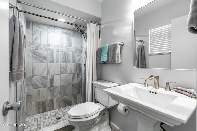 bathroom with a shower with shower curtain, toilet, and sink