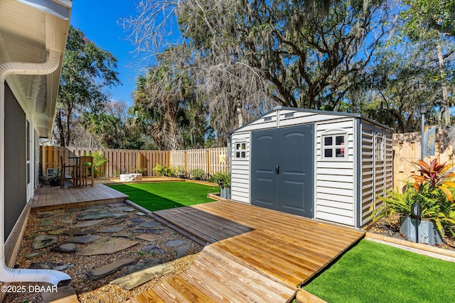 wooden terrace with a shed and a lawn