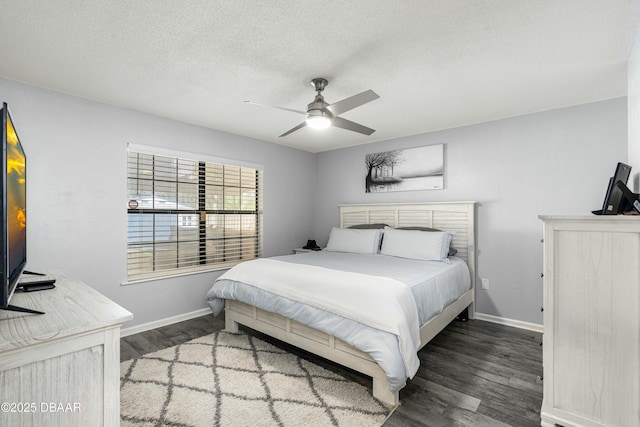 bedroom featuring ceiling fan, dark hardwood / wood-style floors, and a textured ceiling