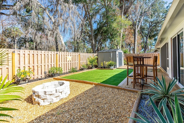 view of yard featuring a fire pit, a patio area, and a shed