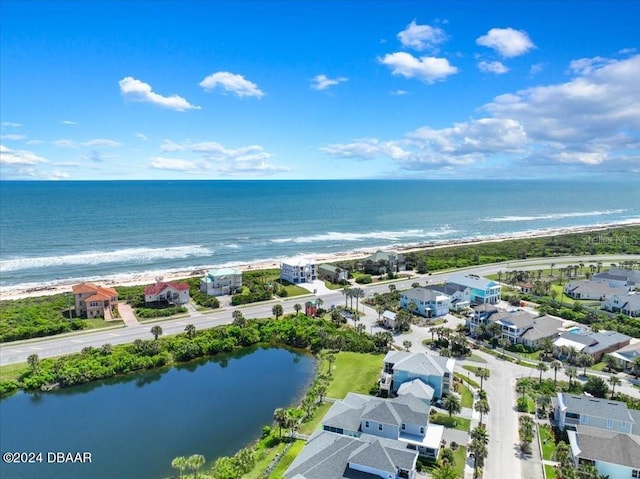 drone / aerial view featuring a water view and a beach view