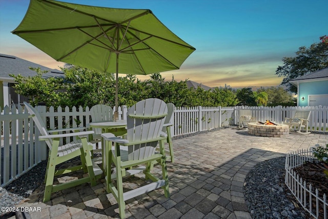 patio terrace at dusk with an outdoor fire pit