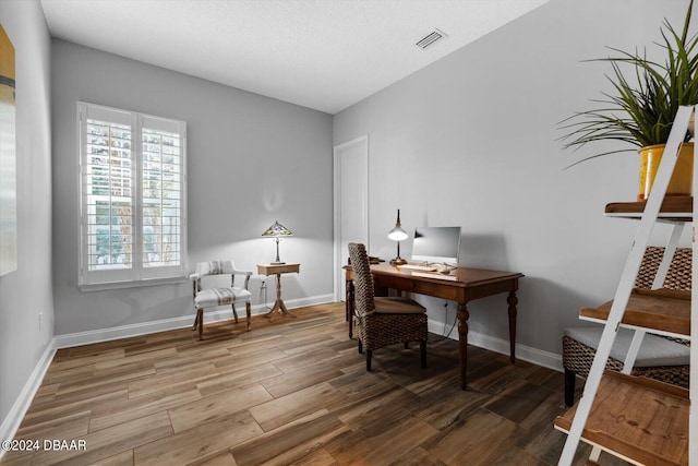 office space with hardwood / wood-style floors and a textured ceiling