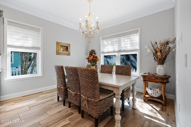 dining area with a chandelier, crown molding, and light hardwood / wood-style flooring