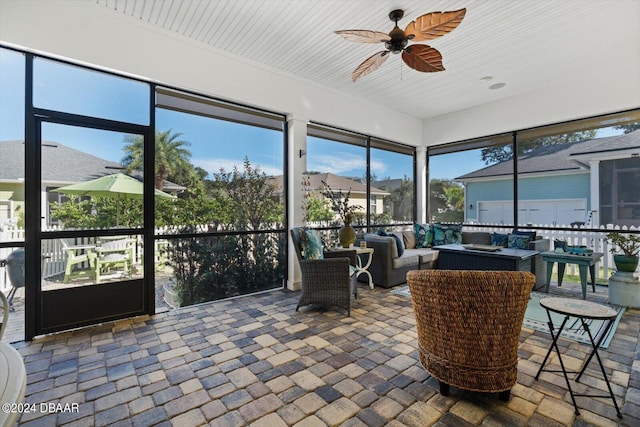 sunroom / solarium featuring ceiling fan