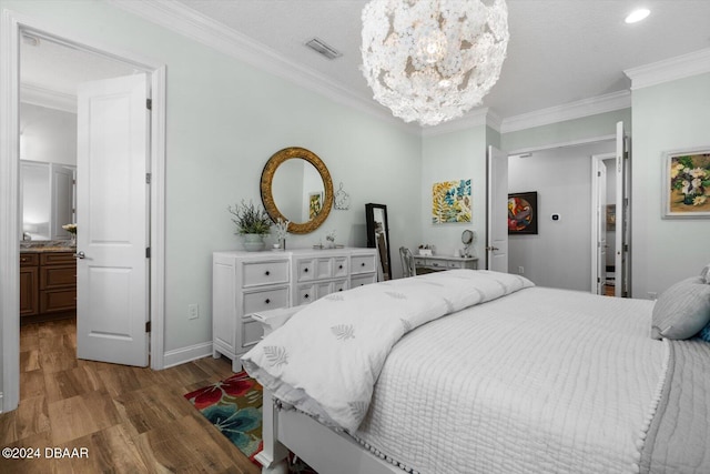 bedroom with wood-type flooring, crown molding, connected bathroom, a textured ceiling, and a notable chandelier