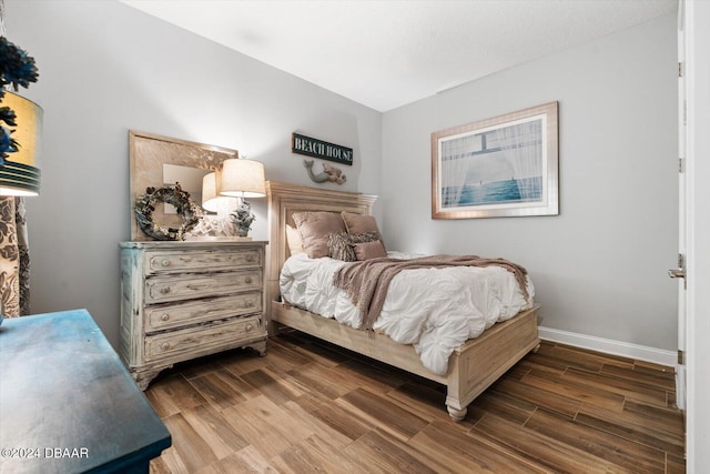 bedroom with dark hardwood / wood-style flooring