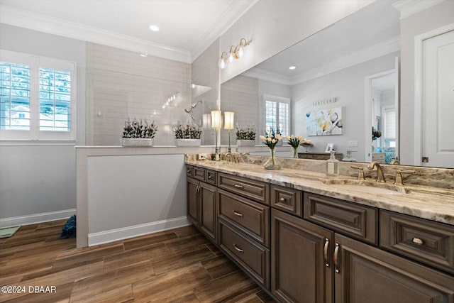 bathroom with hardwood / wood-style floors, ornamental molding, and plenty of natural light